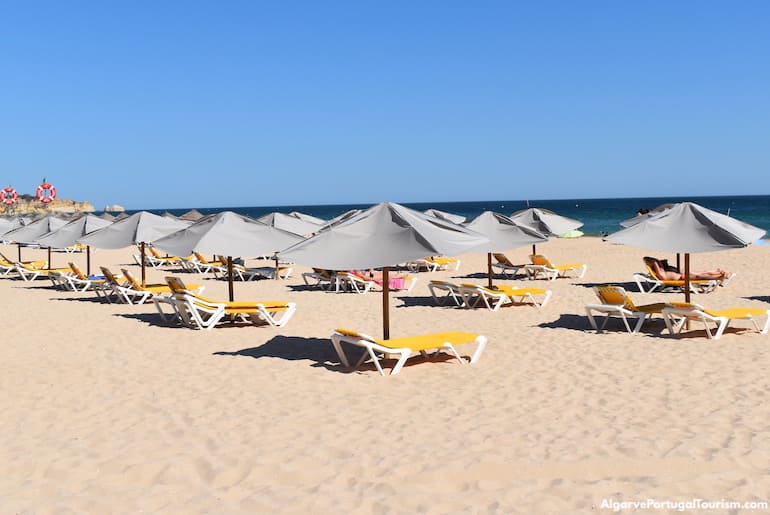 Loungers and beach umbrellas in Alvor Beach, Algarve