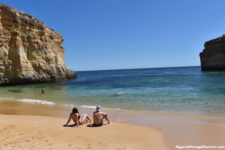Sunbathing by the sea in Barranquinho Beach, Algarve