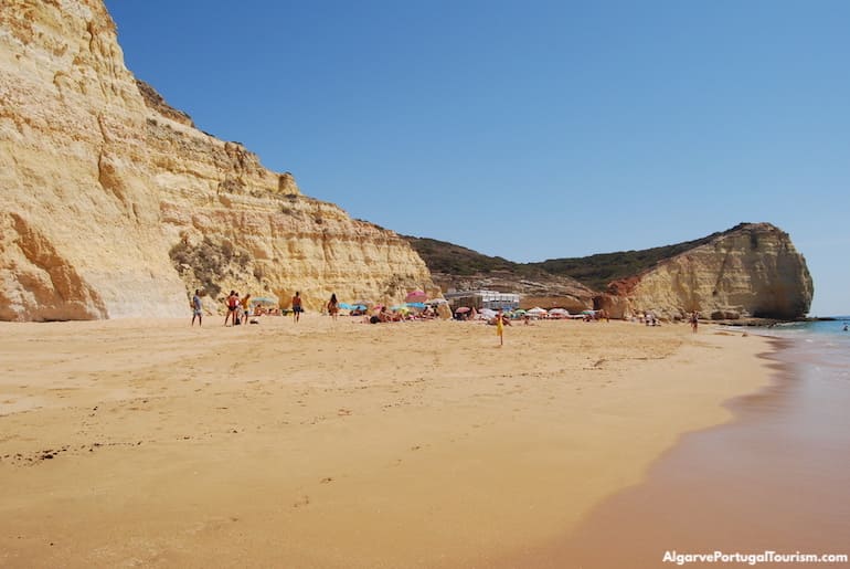 The long Caneiros Beach in Algarve