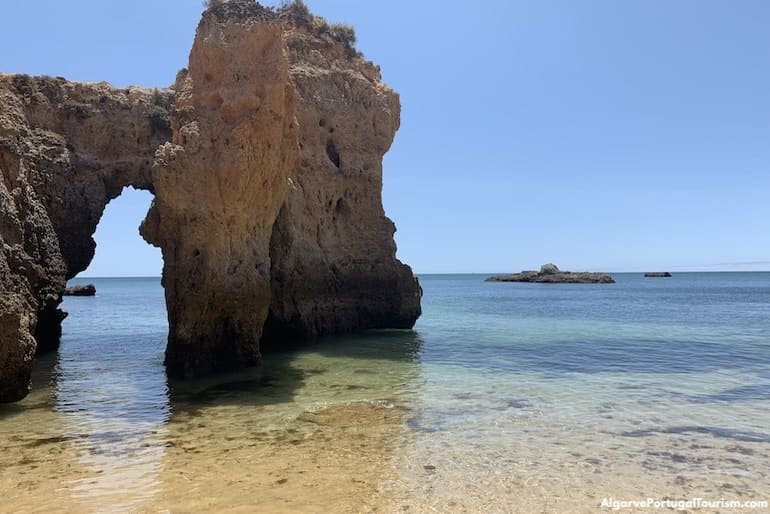 Arch and calm waters in Praia do Submarino, Algarve