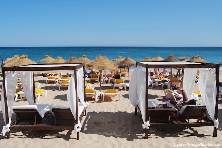 Sunbeds and parasols at the beach in Salema, Algarve